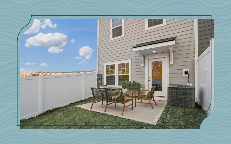 a house with a backyard a patio table and chairs