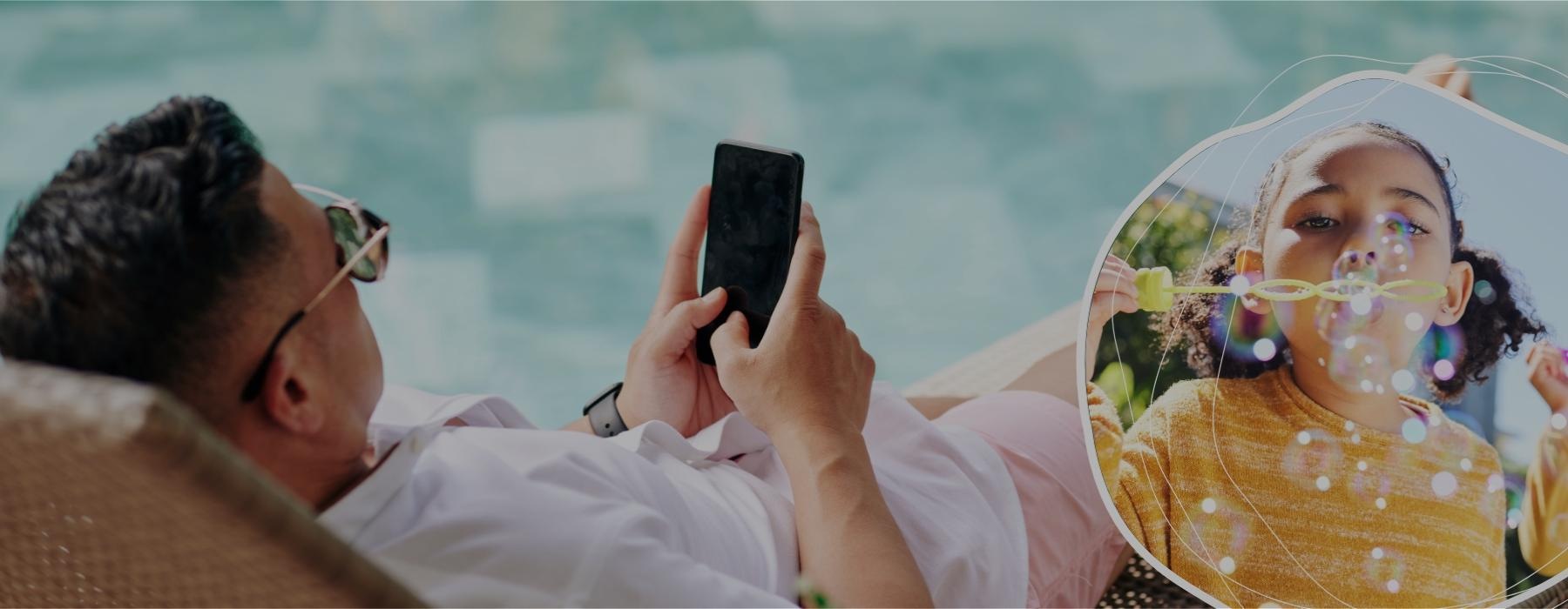 a person sitting on a chair with a phone in hand by a pool and a kid blowing bubbles