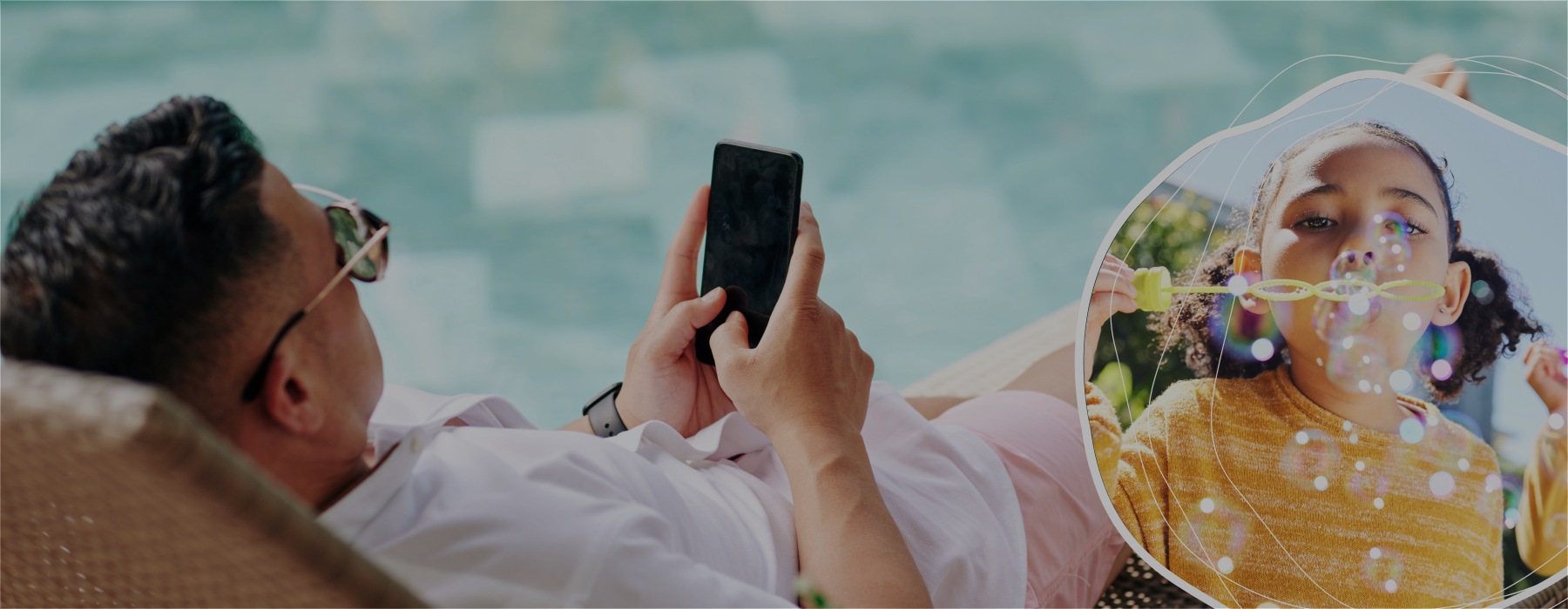 a person sitting on a chair with a phone in hand by a pool and a kid blowing bubbles