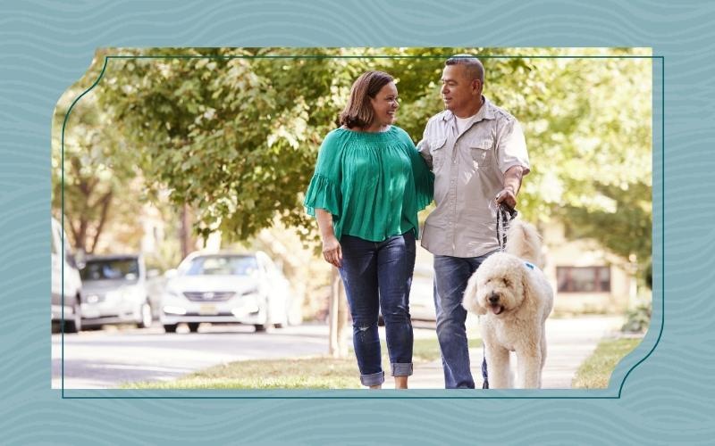 a man and woman walking a dog